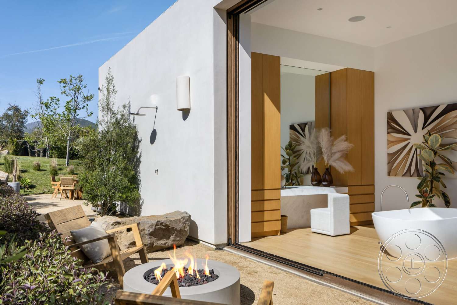 Modern 529 - exterior, outdoor seating area, sliding glass door, contemporary design elements, modern fire pit, minimalist architecture, wooden patio furniture, concrete patio flooring, landscaped garden setting, large panoramic windows, natural stone landscaping, smooth stucco walls, hardwood interior flooring, modern bathtub, circular fire pit with rocks, wood cabinet details