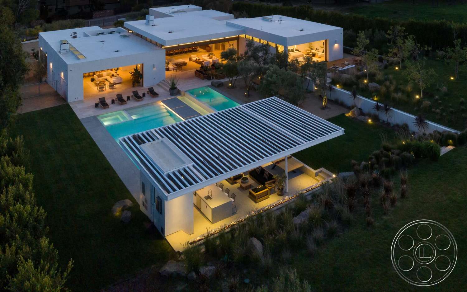 Modern 529 - exterior, landscaped garden, lush greenery, floor-to-ceiling windows, concrete pool deck, rectangular pool, minimalist architecture, stone feature wall, wooden outdoor furniture, modern home design, open-concept living area, metal pergola structure, smooth white stucco walls, covered outdoor patio, sustainable outdoor lighting