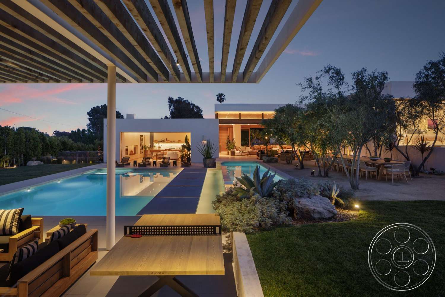 Modern 529 - exterior, low-maintenance plants, floor-to-ceiling windows, grass lawn, modern architectural style, wooden pergola, evening setting, rectangular pool, open-plan living space, landscaped garden area, concrete patio flooring, concrete pool border, built-in outdoor seating, hardwood outdoor dining table
