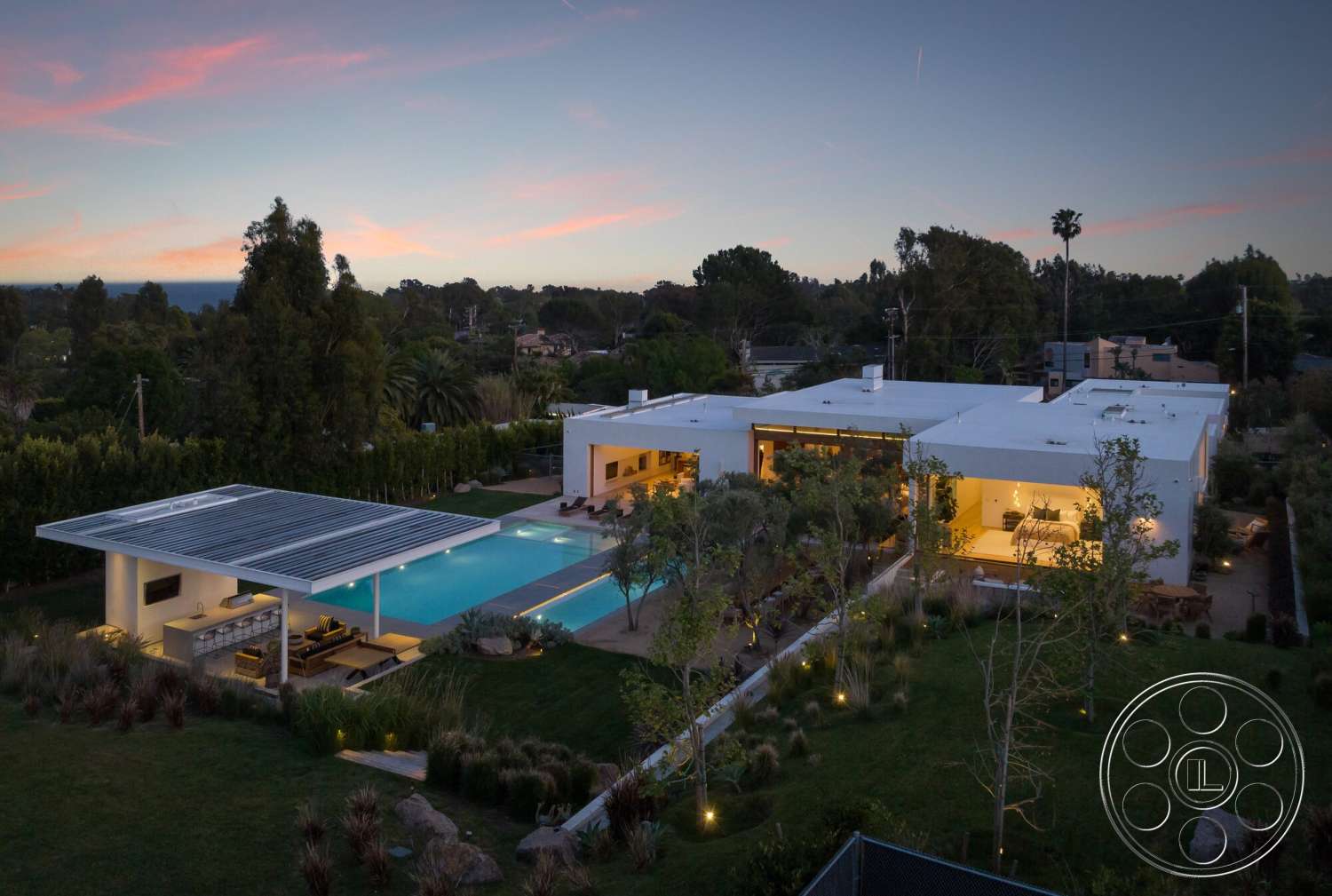 Modern 529 - exterior, white stucco walls, open floor plan, sliding glass doors, modern outdoor furniture, rectangular swimming pool, concrete pool deck, minimalist architecture, surrounding palm trees, flat roof design, solar panel roof, outdoor patio area, landscaped garden with native plants, panoramic garden view, west coast residential setting