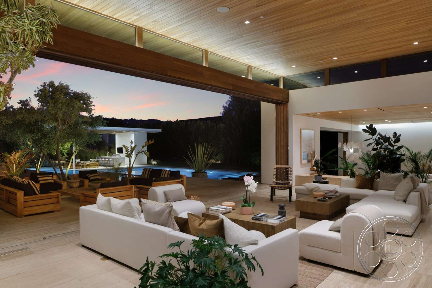 Modern 529 - neutral color palette, wood coffee table, textured area rug, concrete flooring, floor-to-ceiling windows, wood beam ceiling, modern sectional sofa, tropical indoor plants, outdoor pool area view, exposed wood accents, luxury open concept living space, expansive glass doors