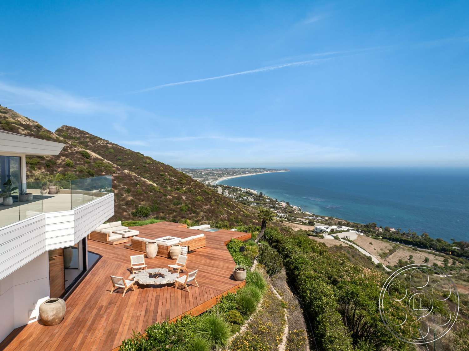Modern 528 - exterior, modern architecture, glass railing, sloped terrain, hillside location, landscape garden, wood deck patio, natural stone fire pit, coastal ocean view, multiple seating area, open outdoor entertainment space