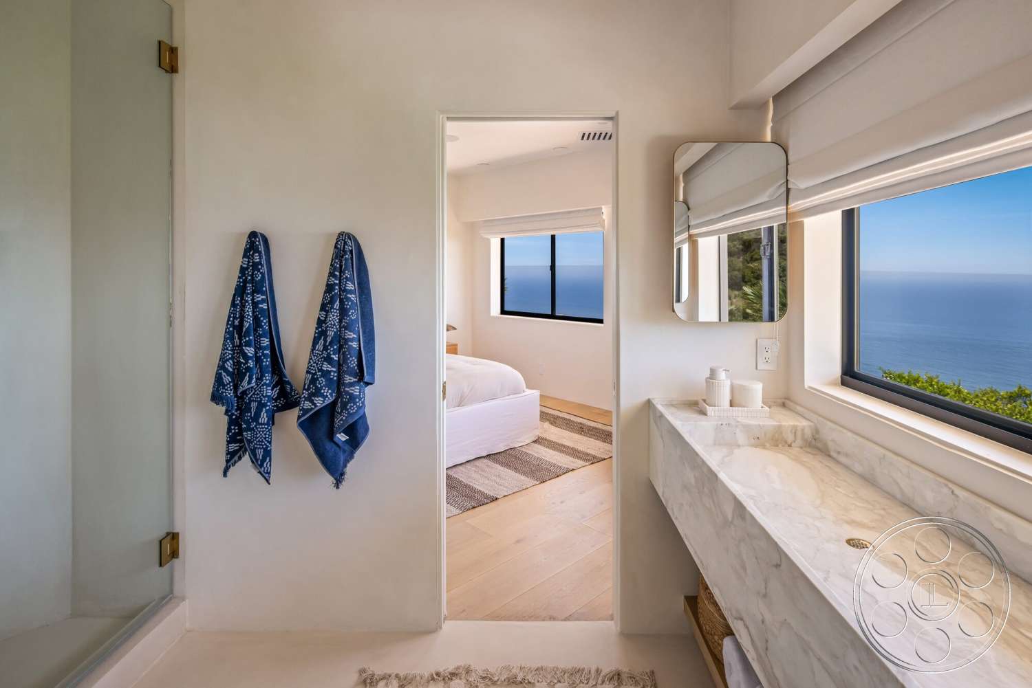 Modern 528 - neutral color palette, hardwood flooring, minimalist design, glass shower enclosure, floor-to-ceiling windows, ocean view, textured plaster walls, modern mirror, marble bathroom countertop