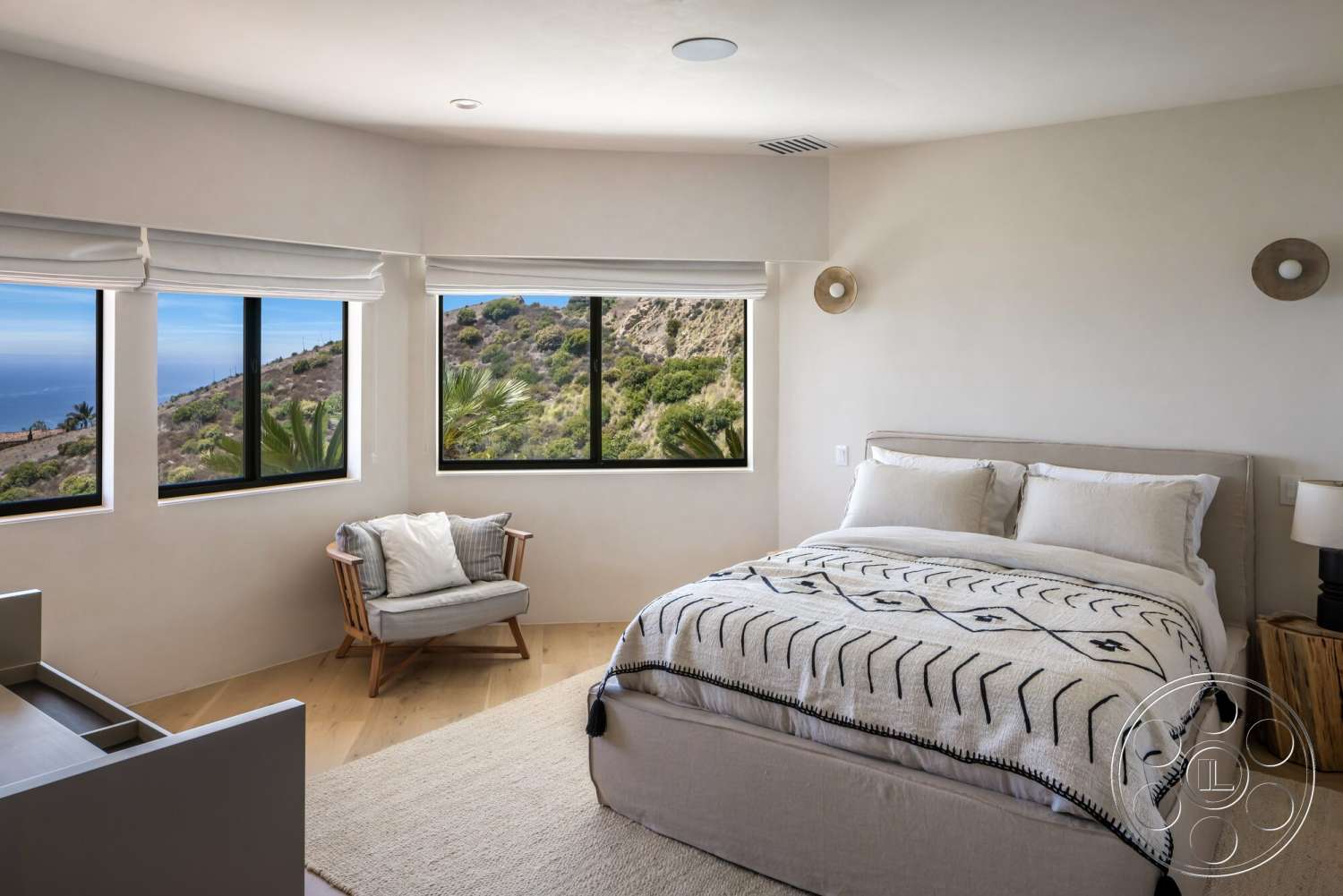 Modern 528 - neutral color palette, light wood flooring, floor-to-ceiling windows, textured plaster walls, contemporary bedside lamp, modern bed frame, decorative throw blanket, mid-century modern armchair, substantial mountain views