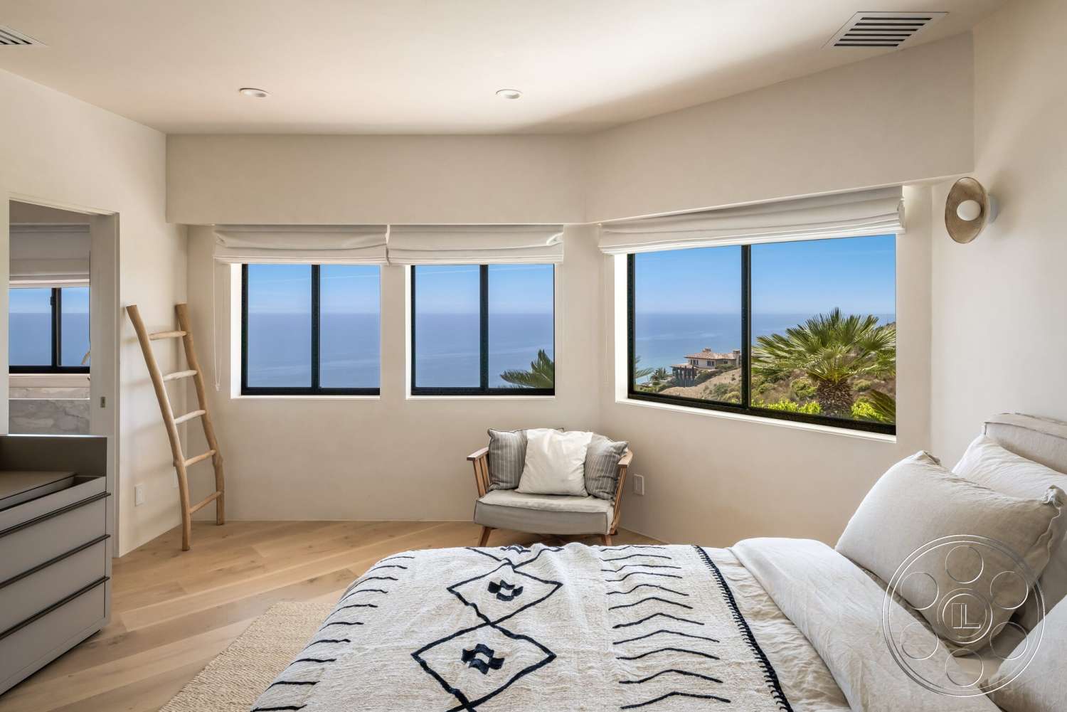 Modern 528 - neutral color palette, natural light, minimalist design, light wood flooring, textured bedding, floor-to-ceiling windows, decorative throw pillows, coastal view, modern light fixture, contemporary armchair, smooth plaster walls, angled bay window, built-in dresser