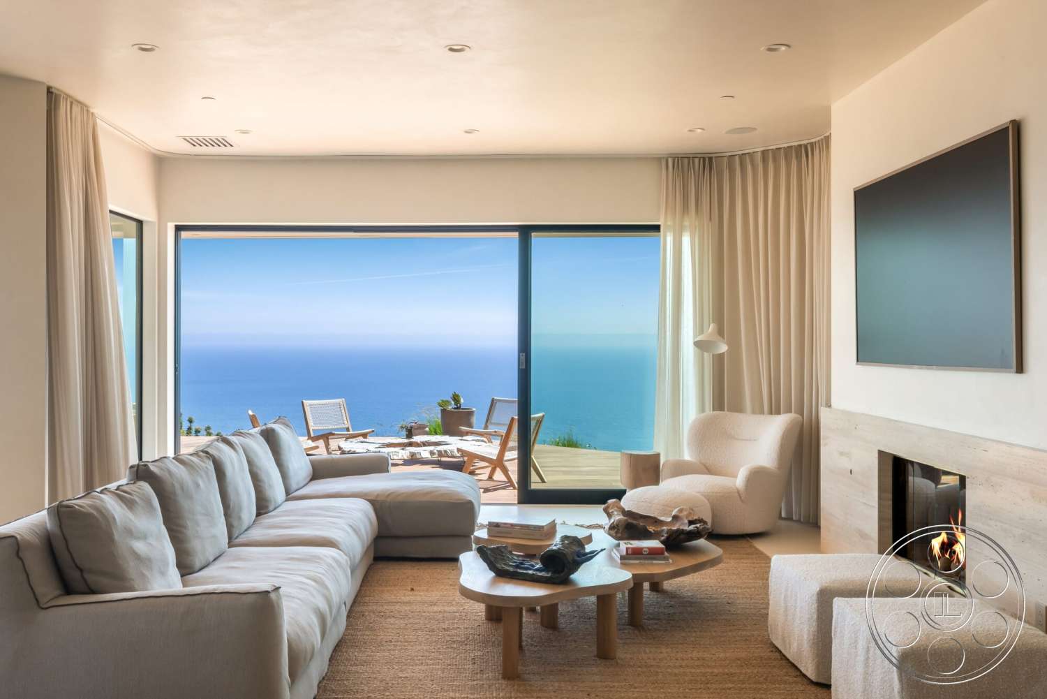 Modern 528 - textured area rug, floor-to-ceiling windows, ocean view, natural wood coffee table, open concept living area, modern accent lighting, wooden deck view, sheer curtain drapes, light-colored wall treatment, minimalist armchair, concrete fireplace wall, sofa with plush fabric upholstery
