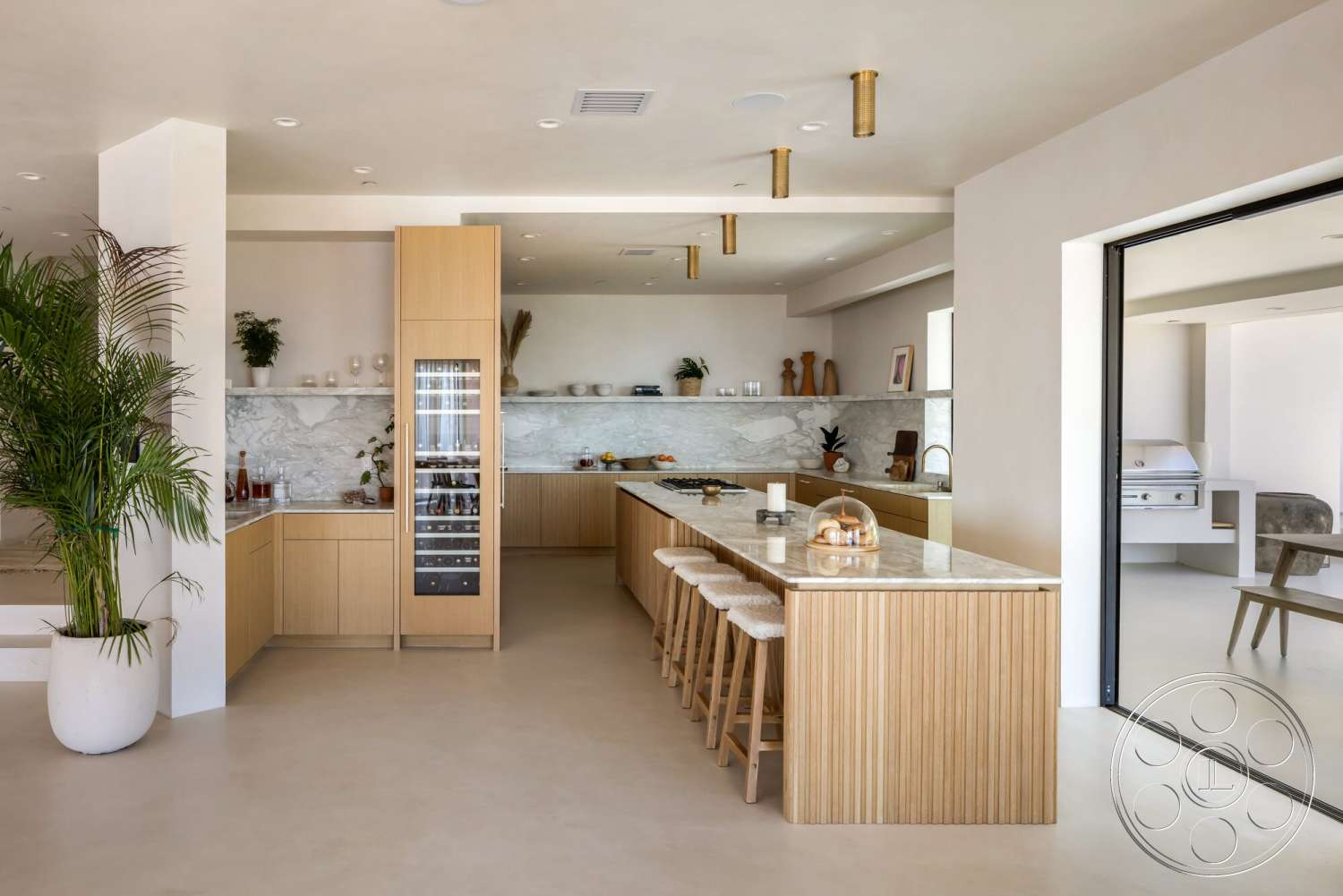 Modern 528 - minimalist design, stainless steel appliances, polished concrete flooring, light wood cabinetry, glass sliding door, recessed lighting fixtures, open-concept kitchen, marble kitchen countertop, kitchen island with seating, tall indoor plant, exposed pendant lighting