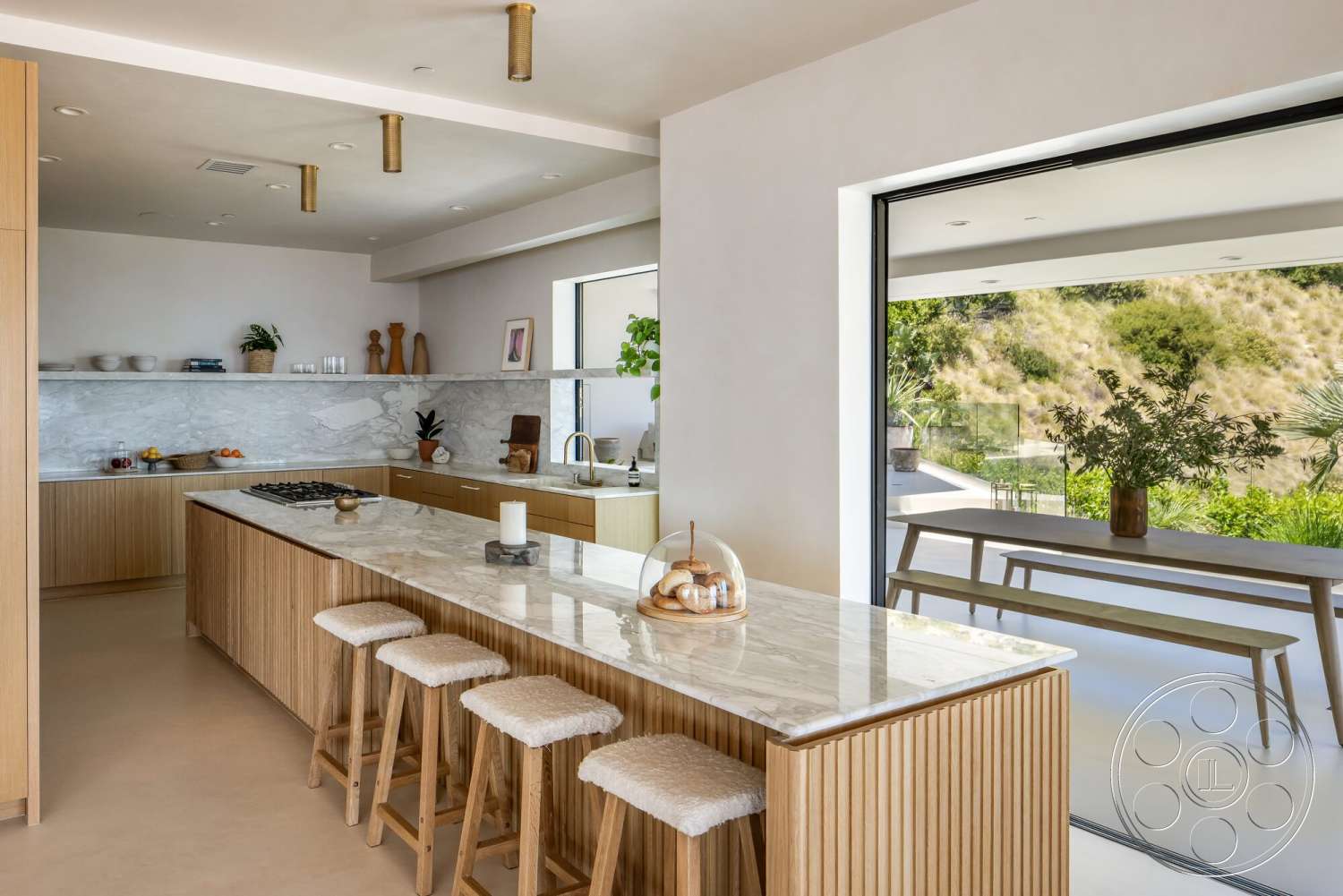 Modern 528 - neutral color palette, minimalist design, wood cabinetry, greenery view, floor-to-ceiling windows, textured ceiling, large sliding glass doors, natural light flooding, marble kitchen countertops, open concept kitchen, smooth plaster walls, spacious kitchen layout, contemporary kitchen island, light wood bar stools
