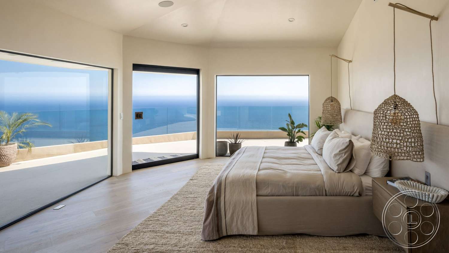 Modern 528 - neutral color palette, textured area rug, open floor plan, floor-to-ceiling windows, minimalist decor with potted plants, plastered wall finish, wooden bedroom floors, queen-sized bed with linen bedding, woven pendant light fixtures, modern nightstand with natural wood finish, ocean view from large glass windows, curved wall architecture