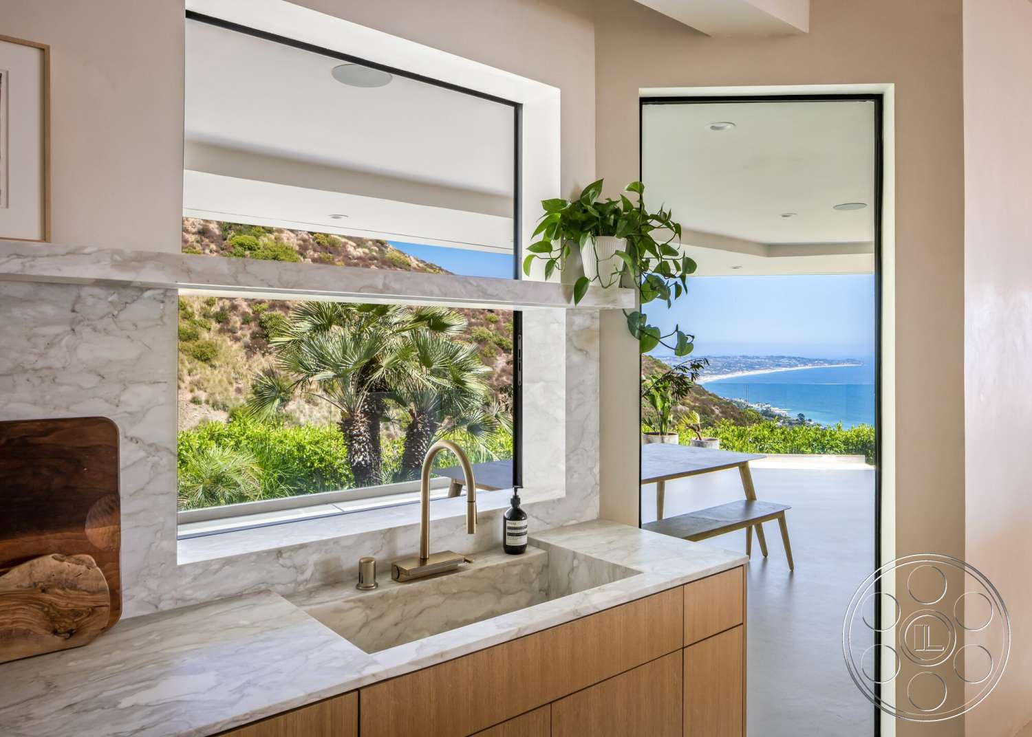 Modern 528 - neutral color palette, floor-to-ceiling windows, under-cabinet lighting, panoramic ocean view, open kitchen layout, marble kitchen countertop, natural light-filled space, minimalist architectural style, smooth plaster wall finish, wood kitchen cabinetry, contemporary faucet design, built-in plant shelf