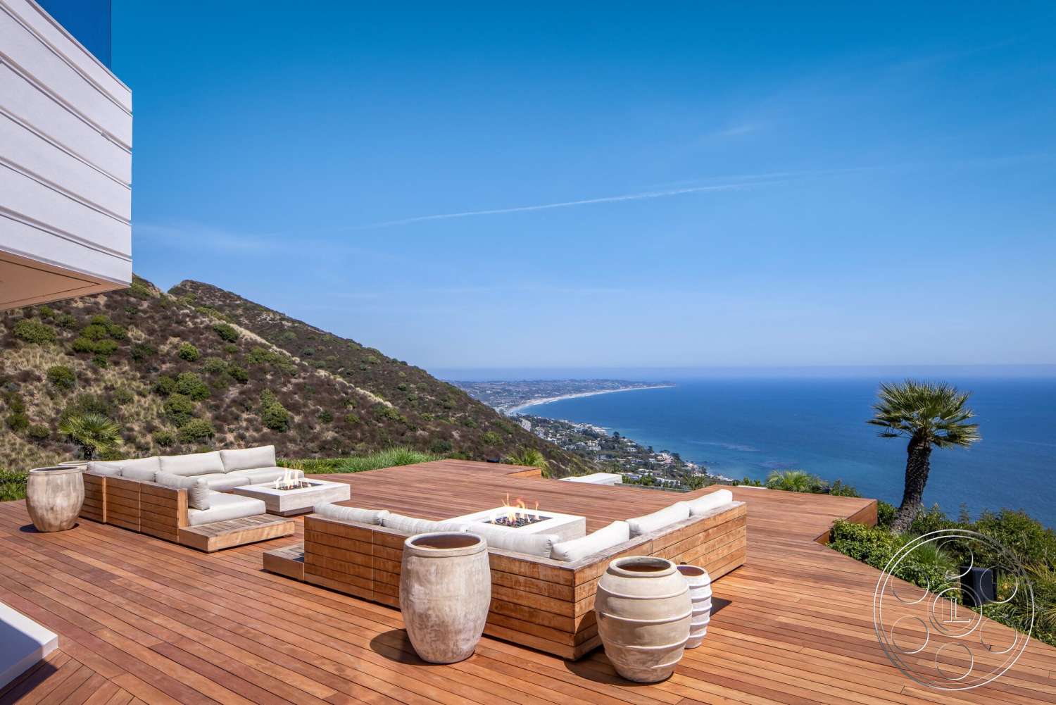 Modern 528 - exterior, minimalist design, lush greenery, concrete planters, ocean view, open-air patio, natural stone steps, landscape garden, contemporary architectural style, modern outdoor seating area, teak wood deck, mountainous setting, heat-resistant outdoor fire pit, floor-to-ceiling glass paneling, sandy beach view