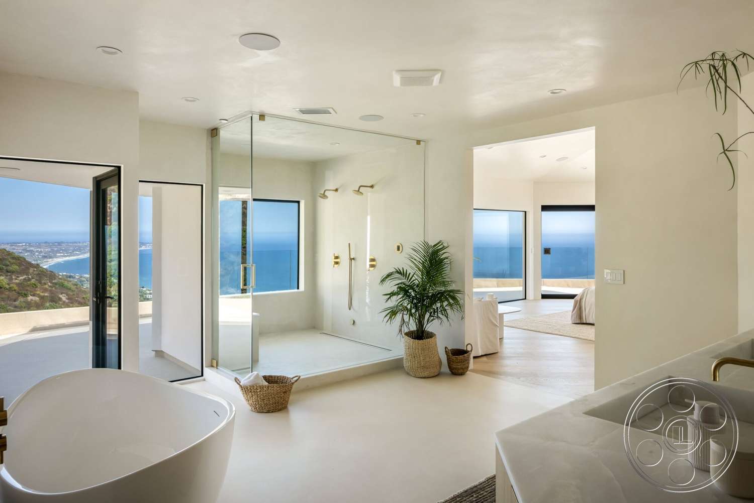 Modern 528 - minimalist design, glass shower enclosure, textured plaster walls, large floor-to-ceiling windows, freestanding soaking tub, concrete bathroom flooring, coastal mountain view, brass shower fixtures, flat panel doors