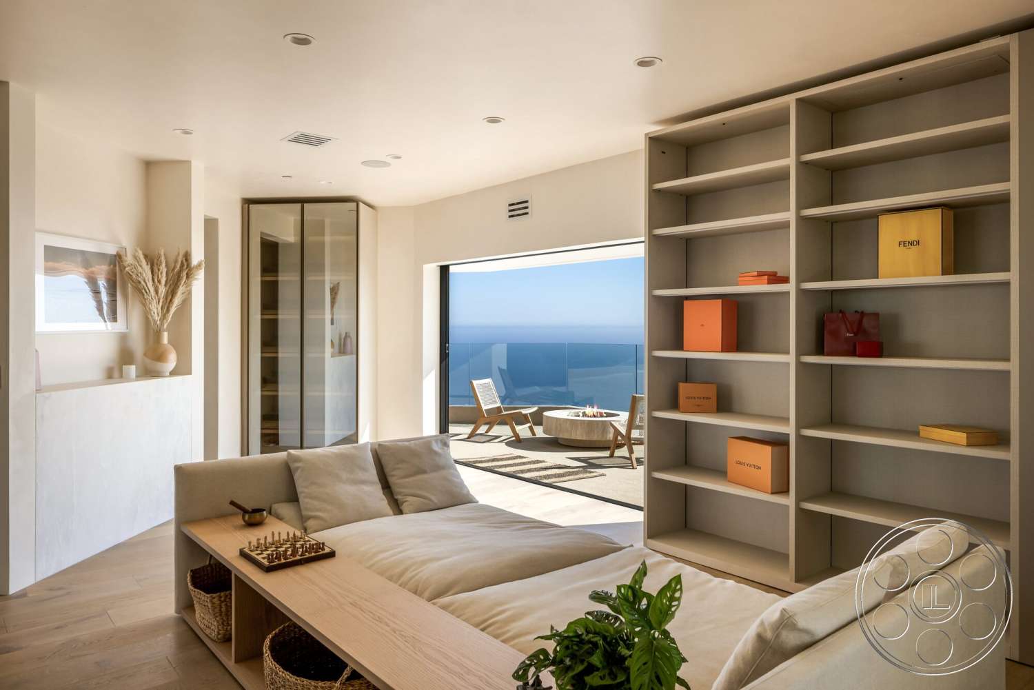 Modern 528 - neutral color palette, natural lighting, open floor plan, light wood flooring, glass sliding doors, floor-to-ceiling windows, textured wall treatment, luxury living space, built-in cabinetry, modern art decor, recessed lighting fixtures, potted indoor plants, contemporary sectional sofa, minimalist shelving unit, outdoor terrace with ocean view, designer display boxes, elegant home atmosphere