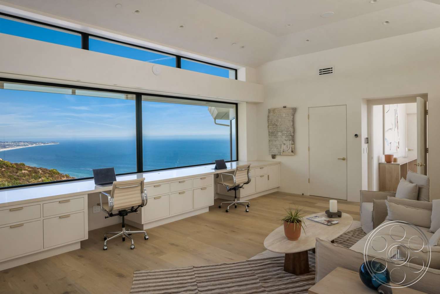 Modern 528 - minimalist decor, natural light, round coffee table, textured area rug, contemporary furniture, open floor plan, light wood flooring, modern light fixtures, floor-to-ceiling windows, ocean view, built-in cabinetry, neutral painted walls, office workspace