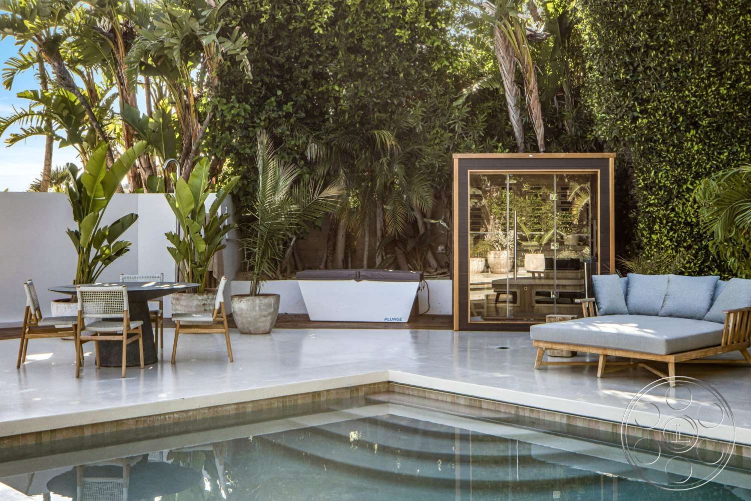 Modern 528 - white walls, exterior, textured concrete flooring, tropical landscaping, tall palm trees, concrete pool deck, rectangular pool, greenery backdrop, contemporary outdoor seating, minimalist outdoor decor, modern outdoor dining area, woven outdoor dining chairs, wood frame patio furniture, glass-enclosed sauna