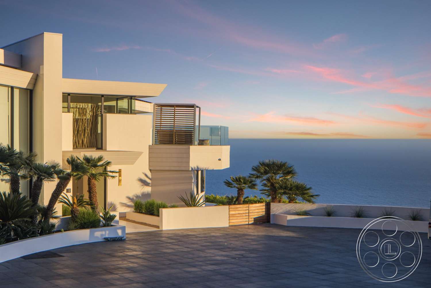 Modern 528 - exterior, landscaped garden, glass railings, stucco walls, large floor-to-ceiling windows, modern home, horizontal wood slats, geometric architecture, flat roof design, palm trees landscaping, stone paver driveway, ocean view setting