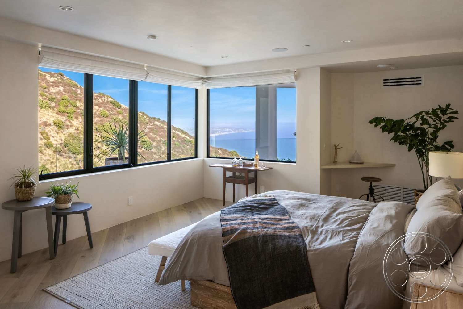 Modern 528 - light wood flooring, floor-to-ceiling windows, contemporary design elements, textured plaster walls, mountain view setting, indoor plant accents, minimalist bedside tables, natural light-filled bedroom, queen-sized bed with decorative blanket