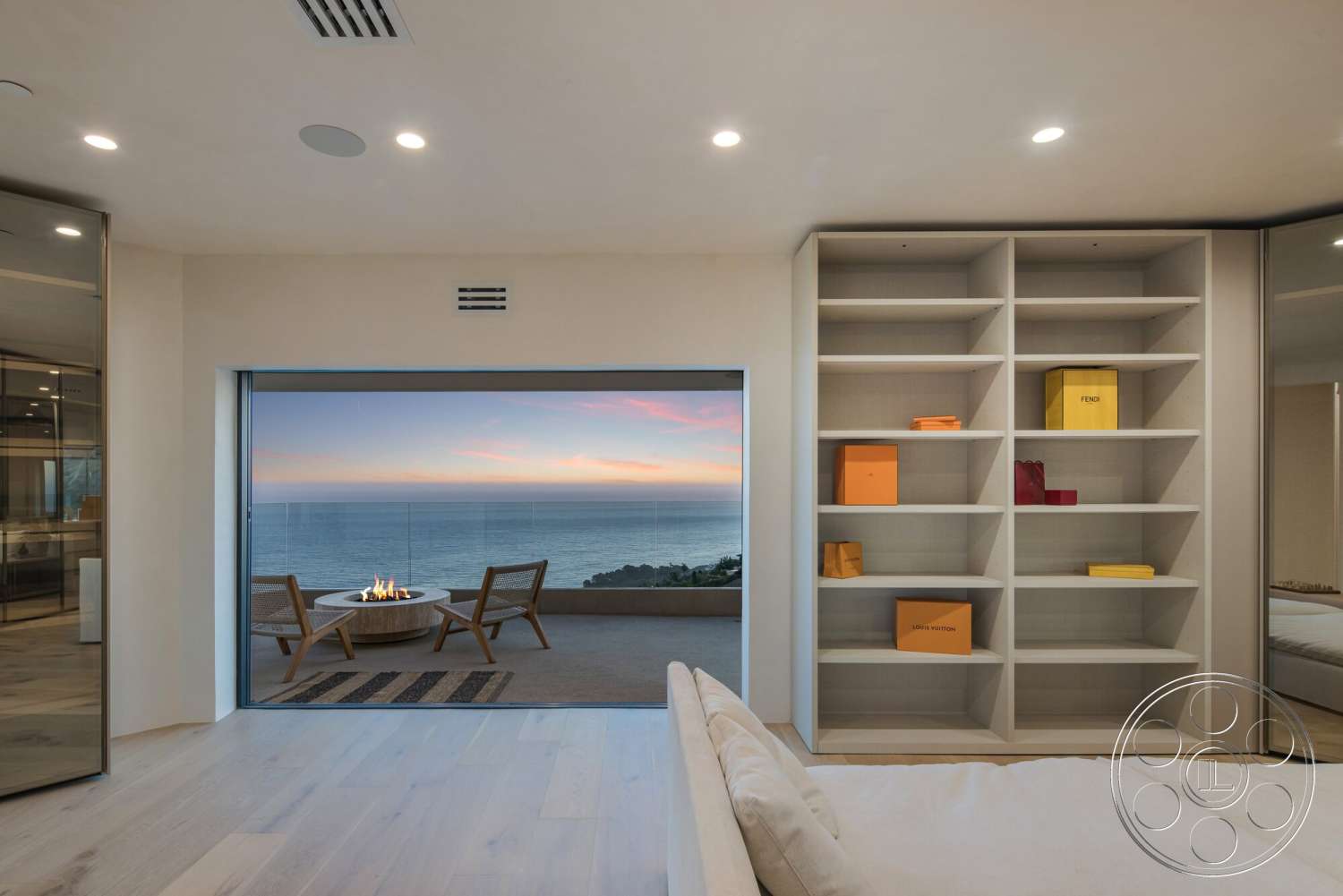 Modern 528 - neutral color palette, glass sliding doors, outdoor patio, floor-to-ceiling windows, modern fire pit, coastal setting, hardwood bedroom floors, minimalist furniture design, ambient recessed lighting, plastered wall treatments, oceanview, contemporary closet shelving, curved patio entrance