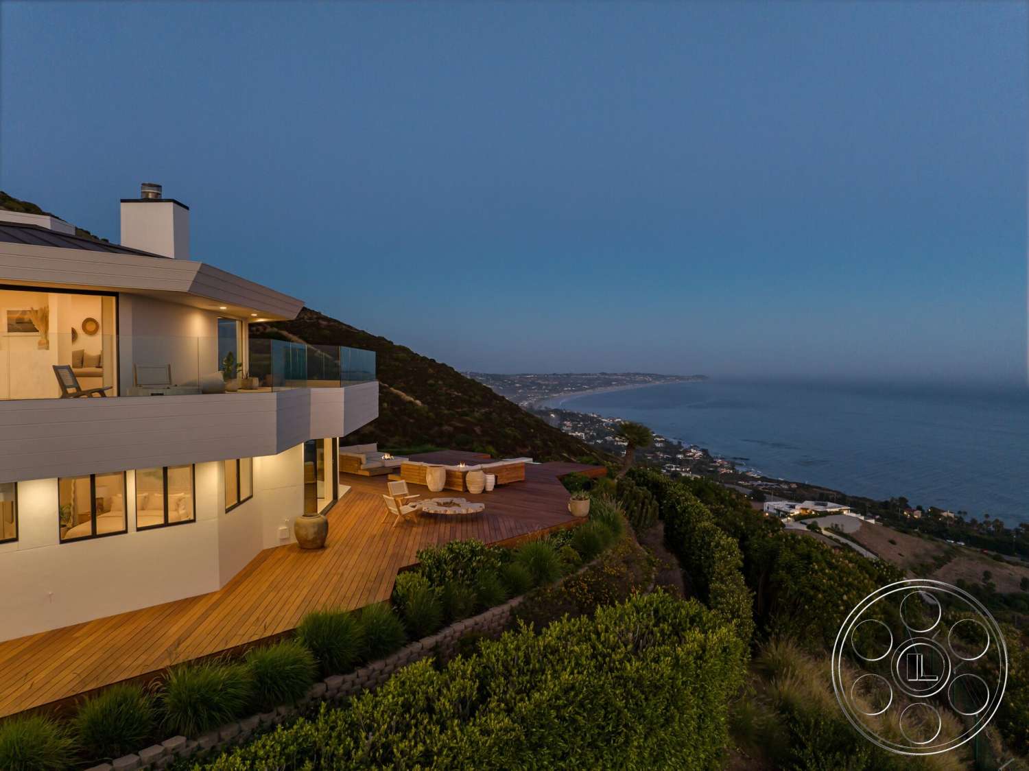 Modern 528 - exterior, landscaped garden, white stucco walls, modern architecture, floor-to-ceiling windows, two-story home, wood deck patio flooring, glass balcony railing, coastal ocean view, mountain hillside location
