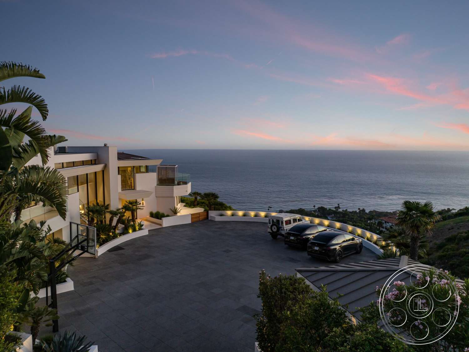 Modern 528 - exterior, tropical plants, floor-to-ceiling windows, modern architectural style, curved driveway, outdoor lighting features, multi-level terrace, horizontal wood slats, integrated outdoor spaces, flat roof design, landscaped garden beds, balcony with glass railing, paved stone driveway, ocean view setting, stucco finish walls