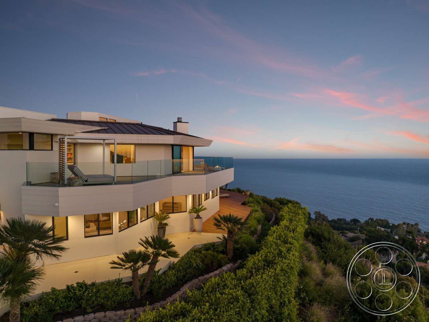 Modern 528 - exterior, landscaped garden, concrete walls, floor-to-ceiling windows, modern architectural style, ocean view, outdoor lounging area, metal roof, flat roof design, wood deck flooring, glass railing balcony, palm trees landscaping, sloped hillside location, rectangular patio