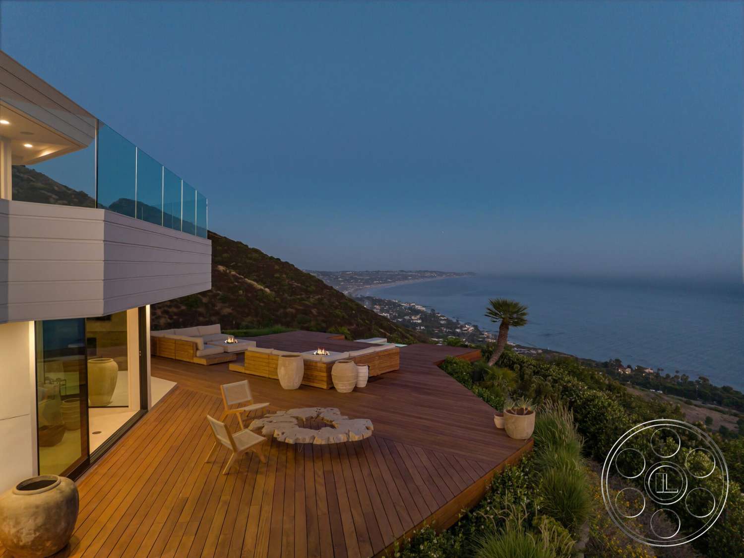 Modern 528 - exterior, minimalist design, sliding glass doors, modern outdoor furniture, natural wood beams, contemporary architecture, landscaped hillside, stone fire pit, wood deck patio, glass balcony railing, oceanfront view, decorative ceramic planters, fire pit seating area, floating wood deck