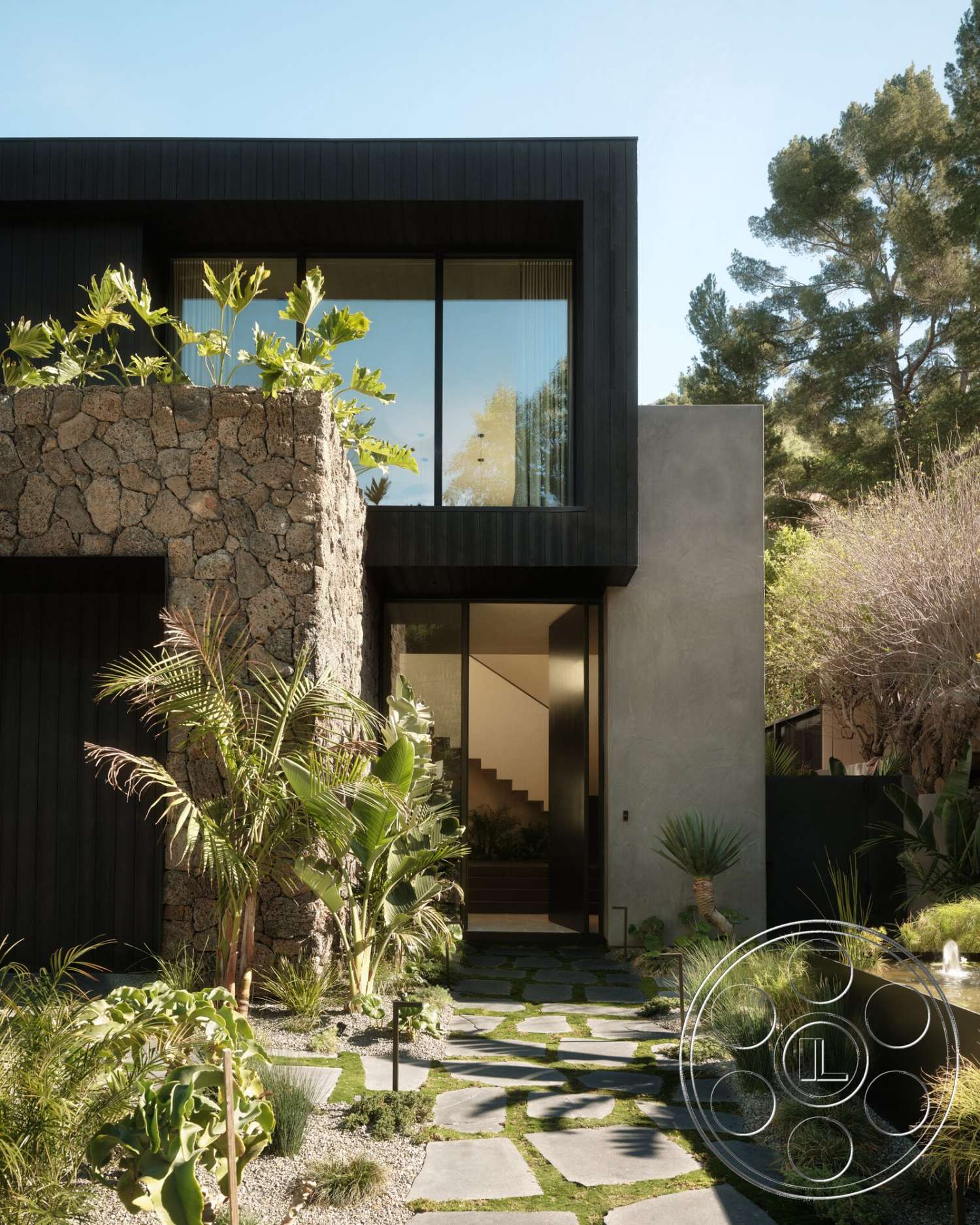 Modern 530 - exterior, modern architecture, water feature, floor-to-ceiling windows, concrete steps, gravel landscaping, tropical foliage, natural stone wall, sustainable landscaping, slate pathway, geometric garden design, black wood paneling