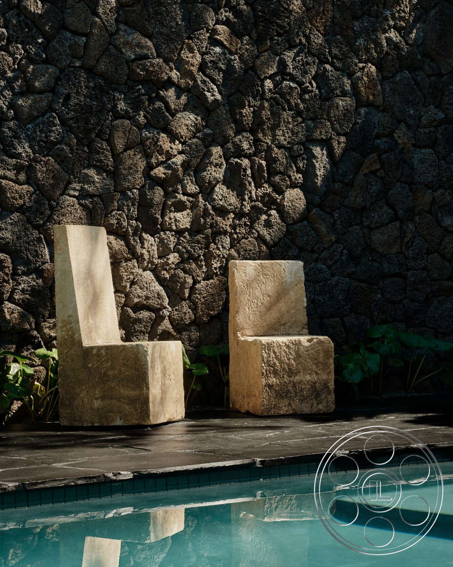Modern 530 - exterior, rectangular swimming pool, natural stone wall, lush greenery setting, slate patio flooring, rough-hewn stone chairs