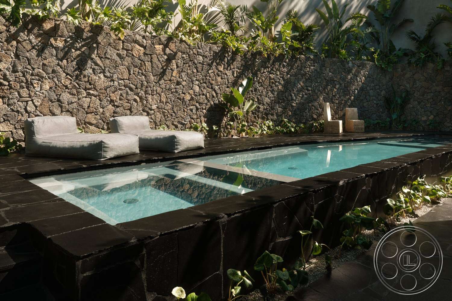 Modern 530 - exterior, tropical foliage, outdoor lounge chairs, rectangular pool, stone feature wall, textured landscaping, concrete patio flooring, gravel garden path, textured concrete steps, black slate pool border