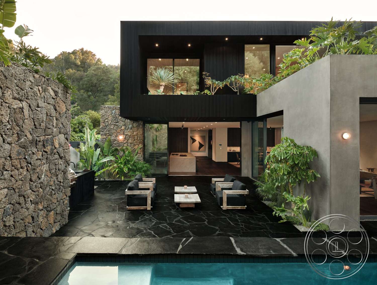 Modern 530 - exterior, stone accent wall, glass sliding doors, concrete walls, rectangular swimming pool, modern architectural style, exposed structural elements, mountain view setting, minimalist outdoor furniture, black stone patio flooring, vegetation landscaping, wood frame seating