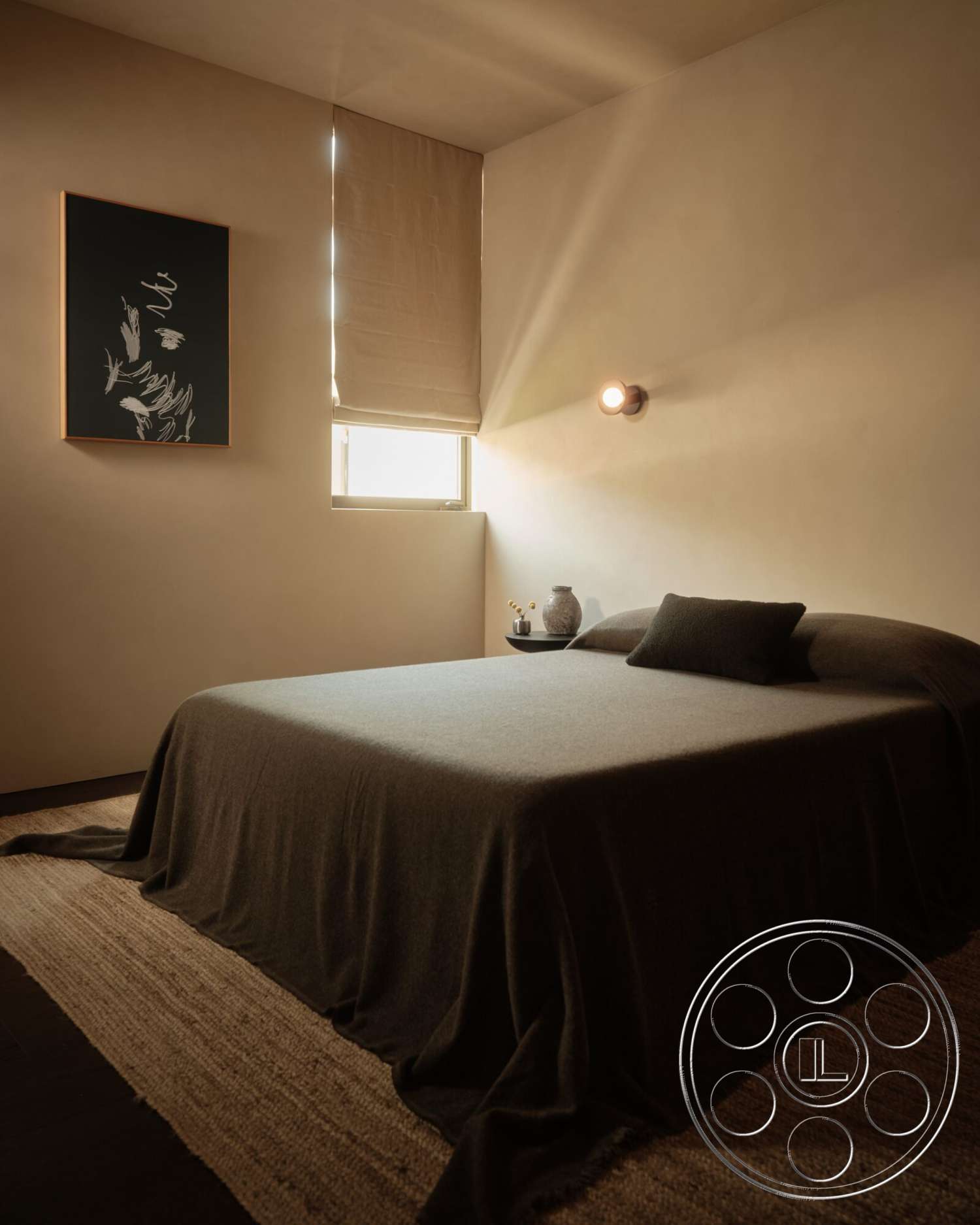 Modern 530 - minimalist decor, neutral color palette, artwork on wall, woven area rug, textured plaster walls, wall-mounted light fixture, hardwood bedroom floors, rectangular bed, roller window shades