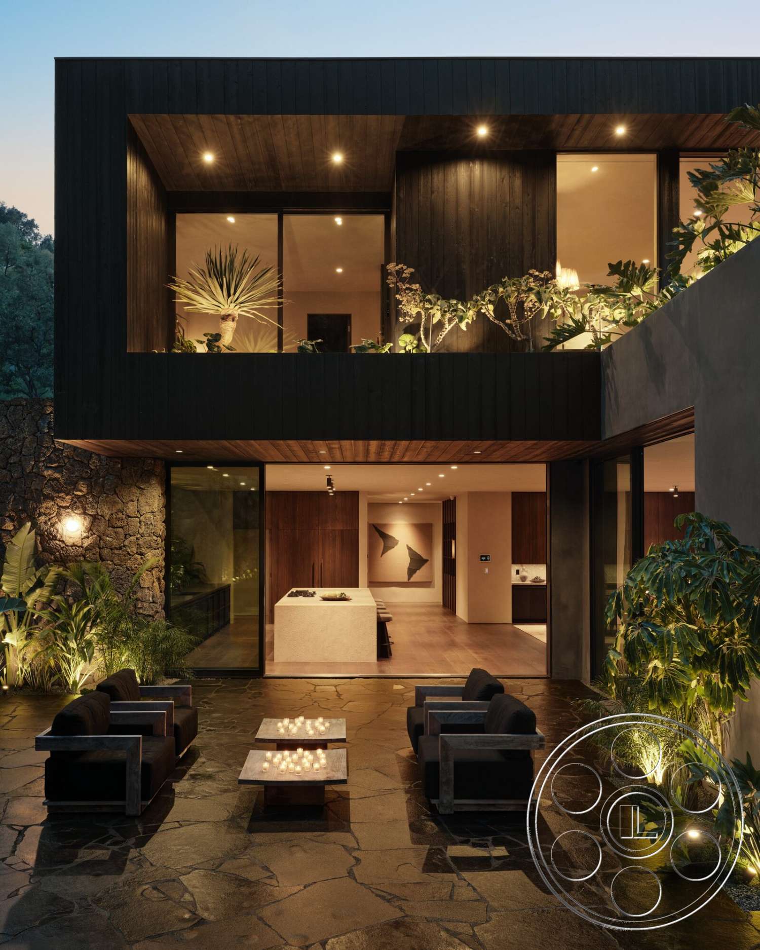 Modern 530 - exterior, large glass sliding doors, open floor plan, modern outdoor furniture, concrete walls, vaulted ceiling, lush tropical landscaping, dark wood paneling, floating steps, stone patio flooring, exposed aggregate concrete, minimalist architectural style, wall-mounted lighting fixtures, rectangular coffee tables, kitchen island with concrete countertop, interior open to outdoor living space