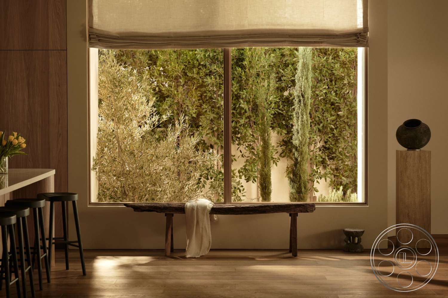 Modern 531 - minimalist decor, contemporary design elements, hardwood living room floors, large window with natural light, neutral painted walls, indoor plant view, wood beam ceiling, exposed wood bench, textured fabric window shade, subtle natural tones