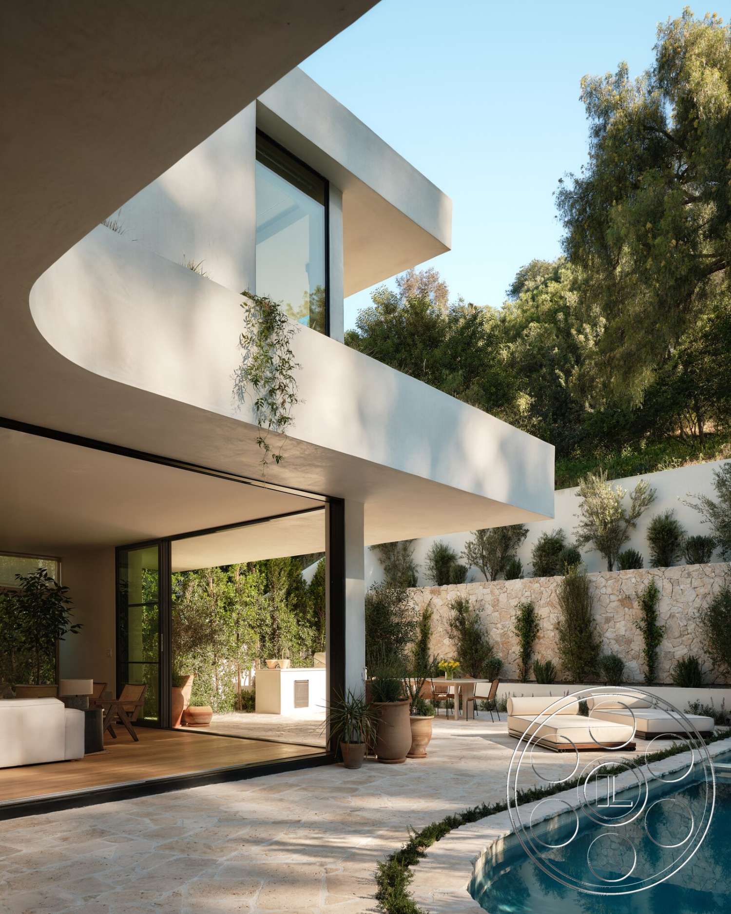 Modern 531 - exterior, glass sliding doors, rectangular swimming pool, modern architectural style, natural stone wall, curved roofline, landscaped garden area, open-concept living area, concrete pool border, concrete patio floor, built-in outdoor kitchen, smooth stucco walls, wood deck seating area, framed floor-to-ceiling windows