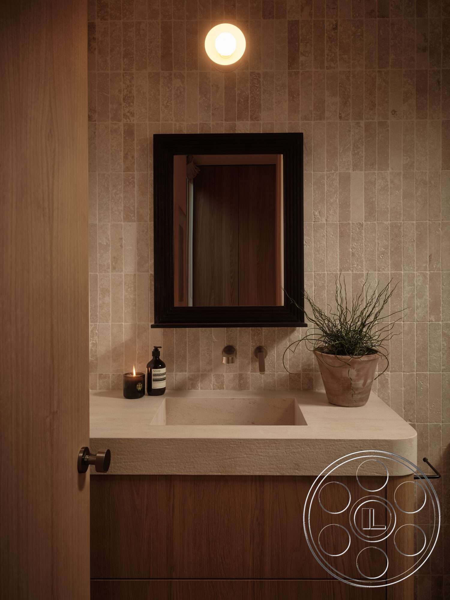 Modern 531 - soft ambient lighting, candle decor, concrete sink countertop, framed wall mirror, potted plant decoration, textured stone bathroom walls, wood bathroom cabinet