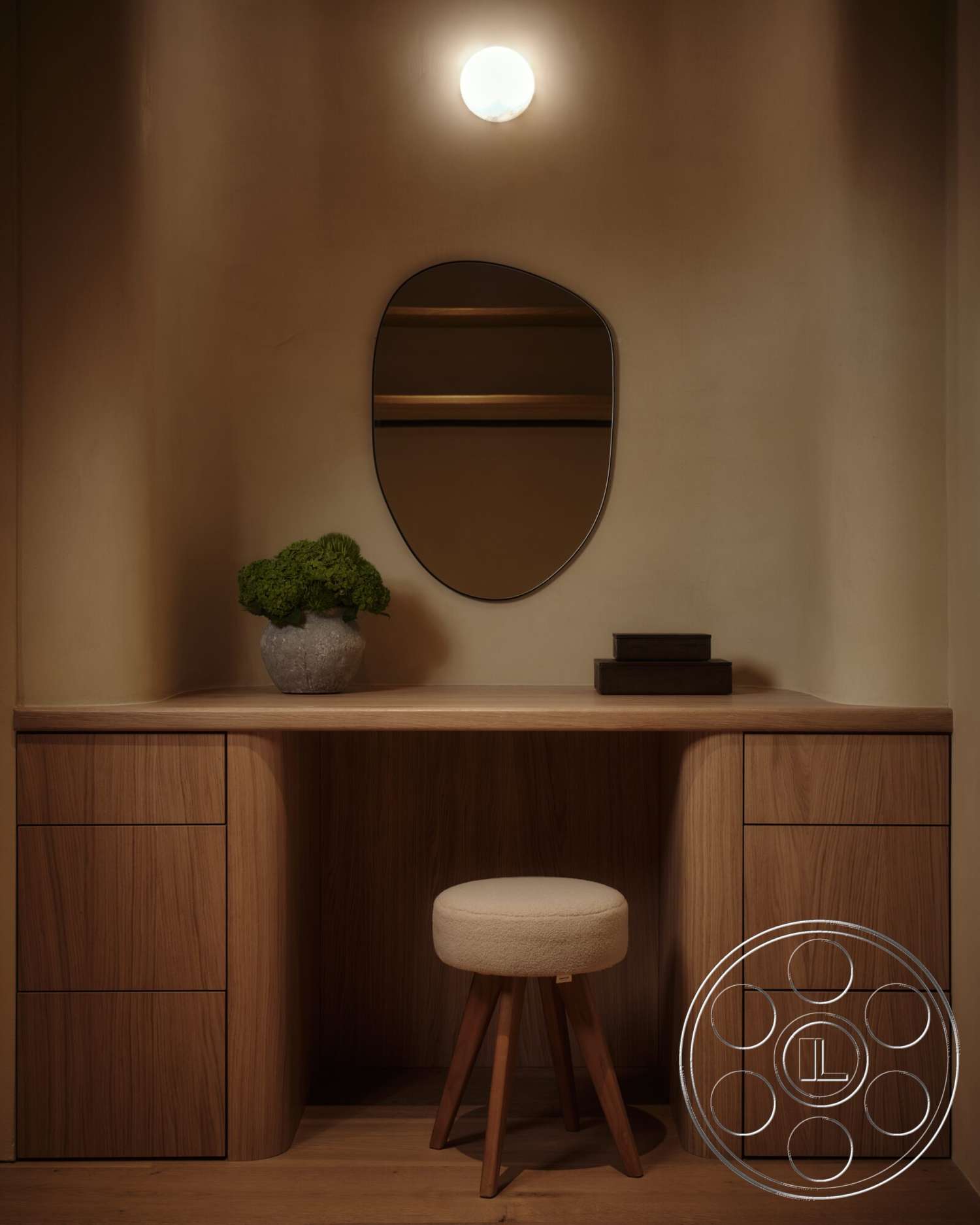 Modern 531 - minimalist design, light wood flooring, round mirror, open shelving, textured wall finish, modern aesthetic, wood desk, potted plant decor, ambient wall lighting, curved wooden desk edges, soft upholstered stool