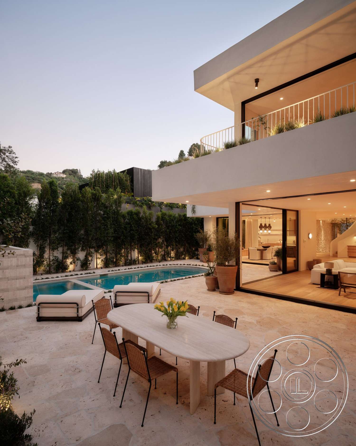 Modern 531 - large windows, exterior, flat roof, glass sliding doors, round dining table, modern landscape design, contemporary outdoor lighting, rectangular pool, woven dining chairs, concrete retaining wall, white painted walls, stone patio flooring, lush greenery surrounding, wood beam balcony railing