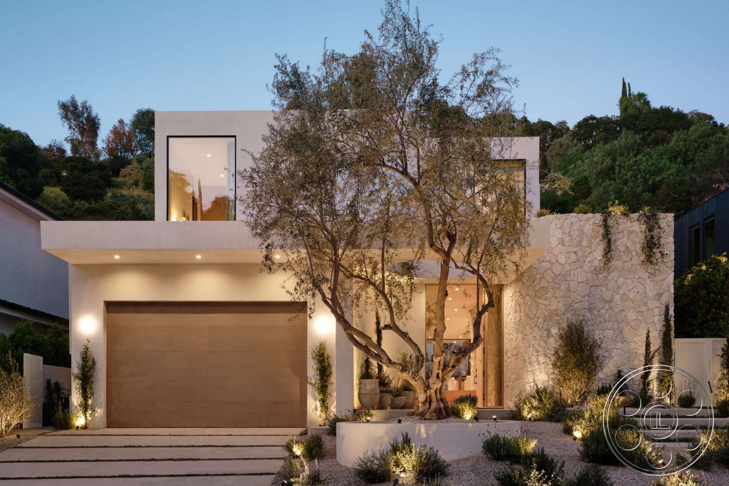 Modern 531 - exterior, modern architectural style, large floor-to-ceiling windows, slate stone driveway, minimalist landscaping, stone feature wall, smooth concrete walls, modern home design, natural stone planter, rectangular entryway, low-maintenance garden beds, wood garage door, lush hillside setting