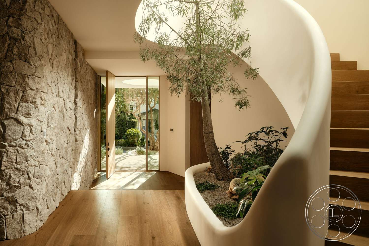 Modern 531 - natural light, glass door, exterior, open floor plan, wooden door, greenery indoors, wooden stair treads, curved staircase, modern interior design, smooth plaster walls, natural stone entry wall, interior plant feature