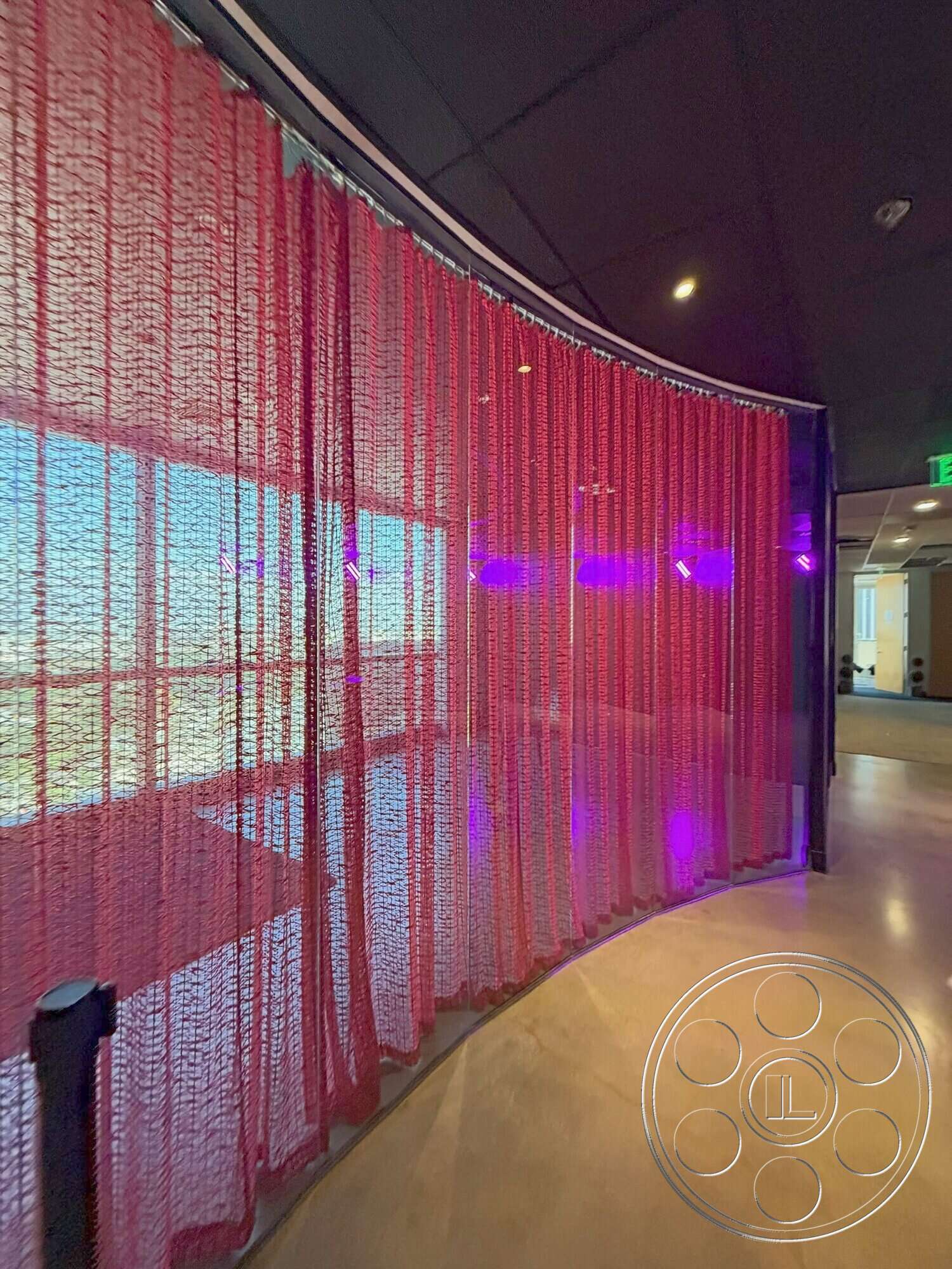 Wilshire Penthouse - polished concrete floor, interior space, modern architectural design, curved fabric partition, red mesh curtain, indirect purple lighting