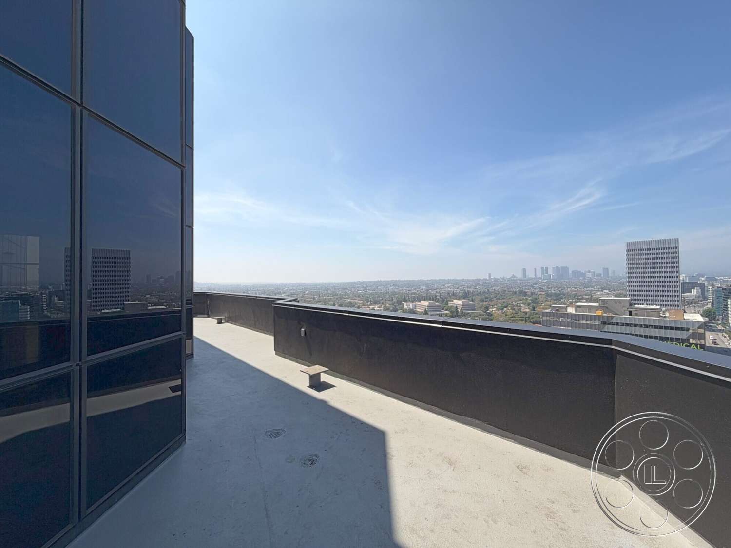 Wilshire Penthouse - exterior, metal railing, modern architectural style, urban skyline view, flat roof design, glass curtain wall, concrete terrace flooring