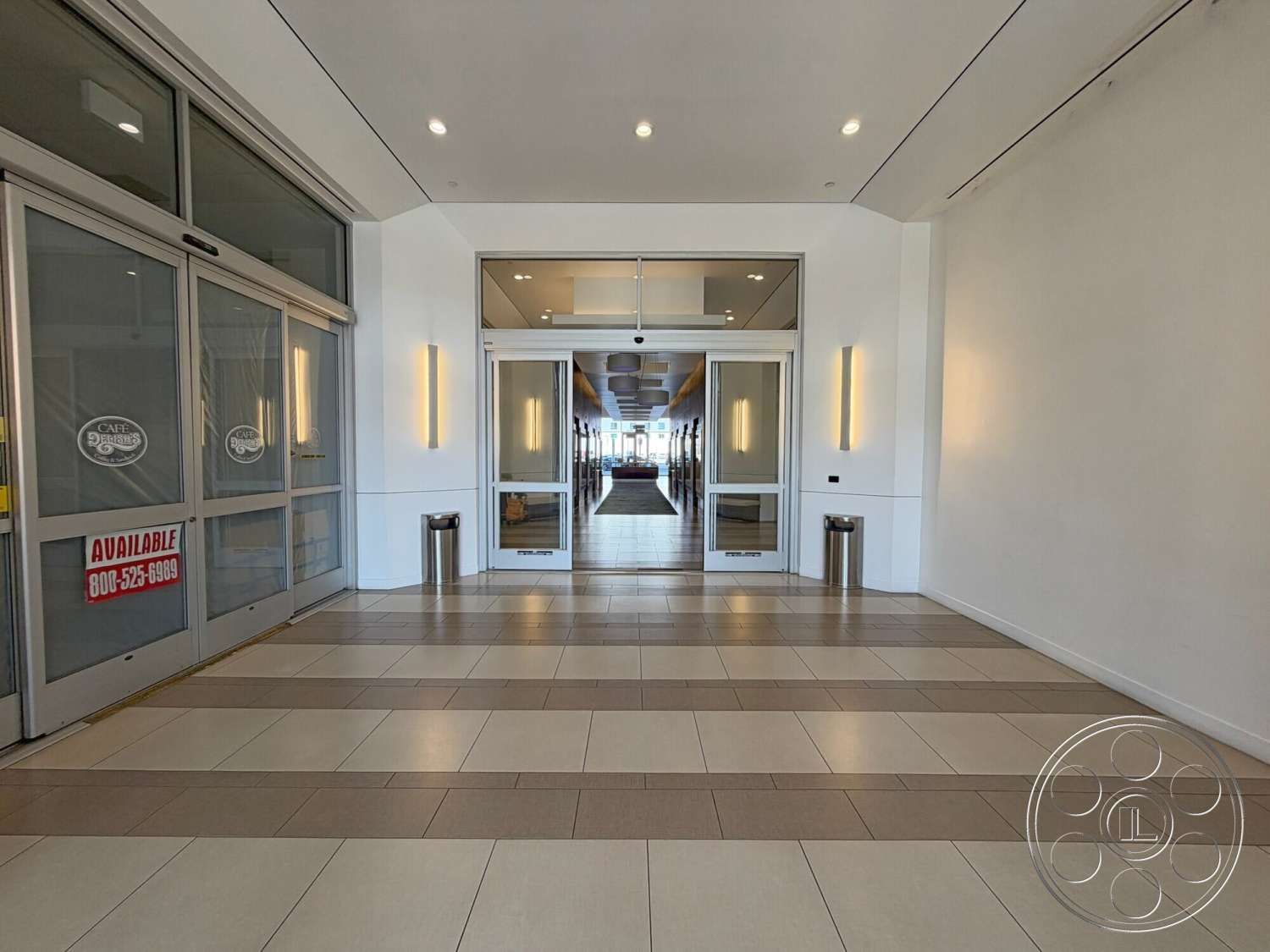 Wilshire Penthouse - tile flooring, modern architectural style, recessed ceiling lights, open foyer, lobby area, white painted walls, exterior entrance, glass entrance doors, large floor tiles, metal trash cans