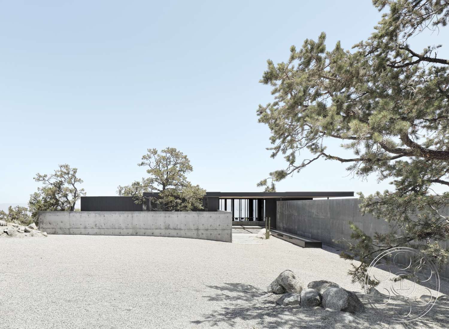 Palm Springs 110 - exterior, flat roof, open space layout, large glass windows, horizontal lines, concrete walls, mountain backdrop, natural setting, gravel driveway, stone landscaping, modern structure, minimalist architectural style, tree landscape features
