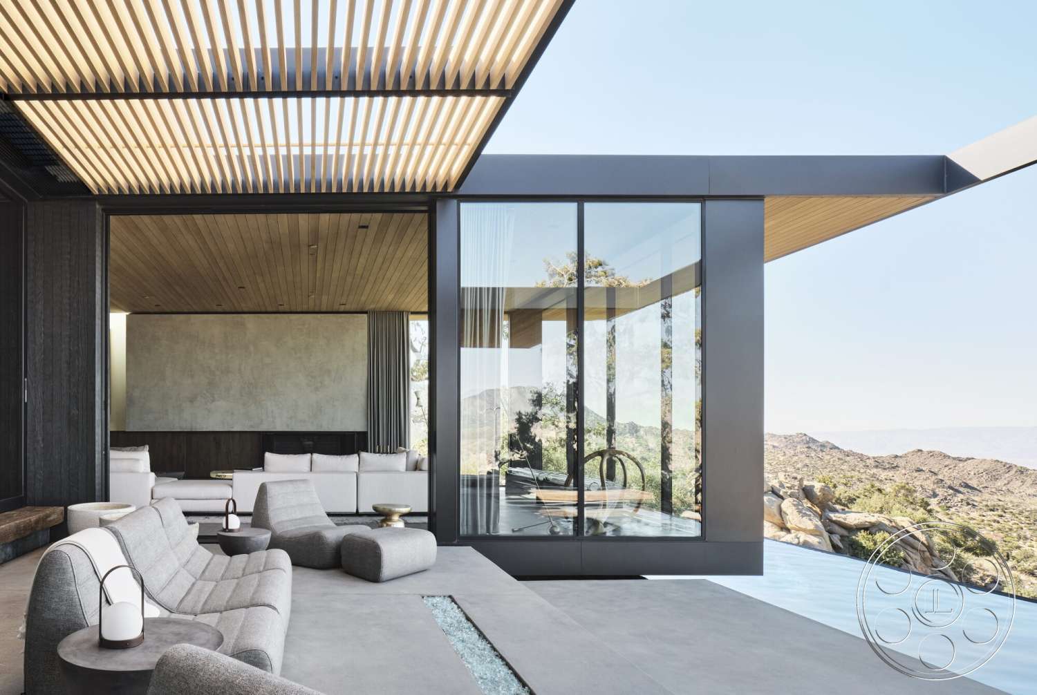 Palm Springs 110 - exterior, open floor plan, polished concrete flooring, outdoor living space, mountain view, contemporary architectural style, textured plaster wall, minimalist furniture design, modern lounge seating, exposed wood ceiling, wood slatted patio cover, glass wall system