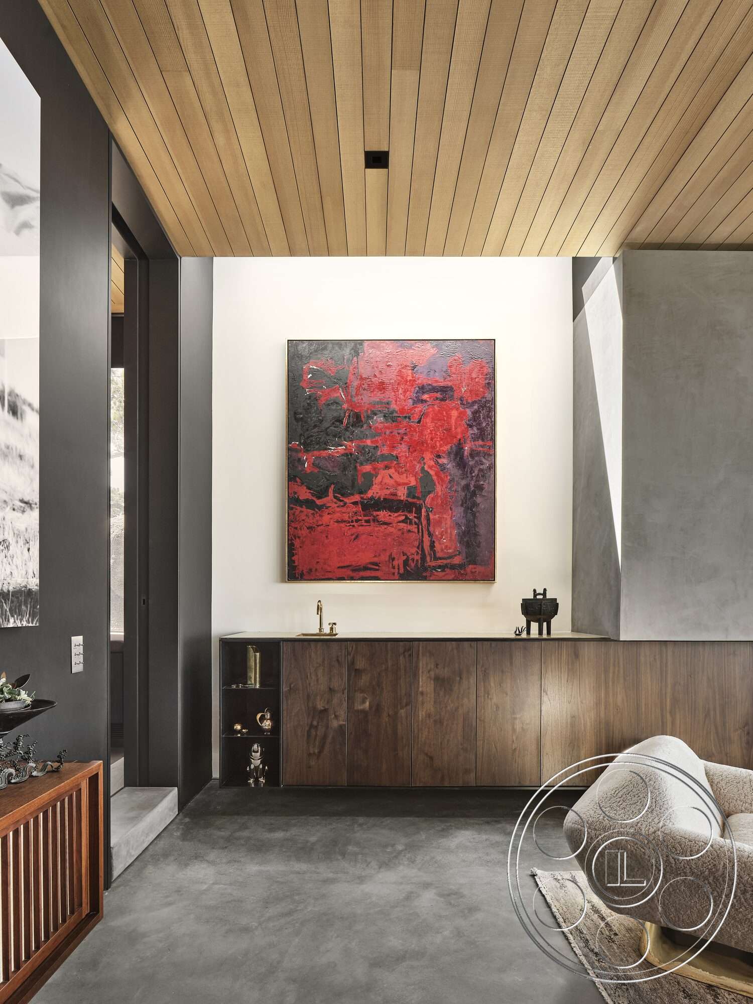 Palm Springs 110 - dark wood cabinetry, abstract wall art, concrete flooring, floor-to-ceiling windows, modern minimalist design, textured plaster wall, artistic decor accents, soft fabric armchair, maple wood ceiling planks