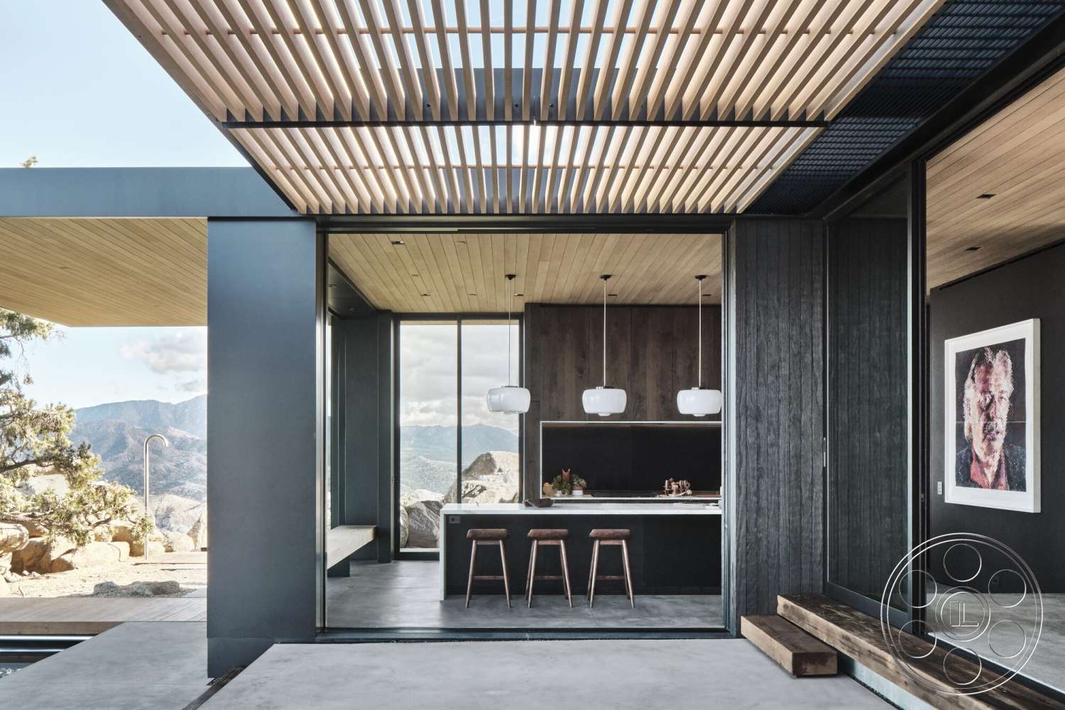 Palm Springs 110 - exterior, open concept layout, floor-to-ceiling windows, dark wood paneling, modern kitchen design, contemporary architectural style, mountain view setting, glass partition walls, wood beam ceiling, concrete patio floor, pendant light fixtures, horizontal slatted wooden roof