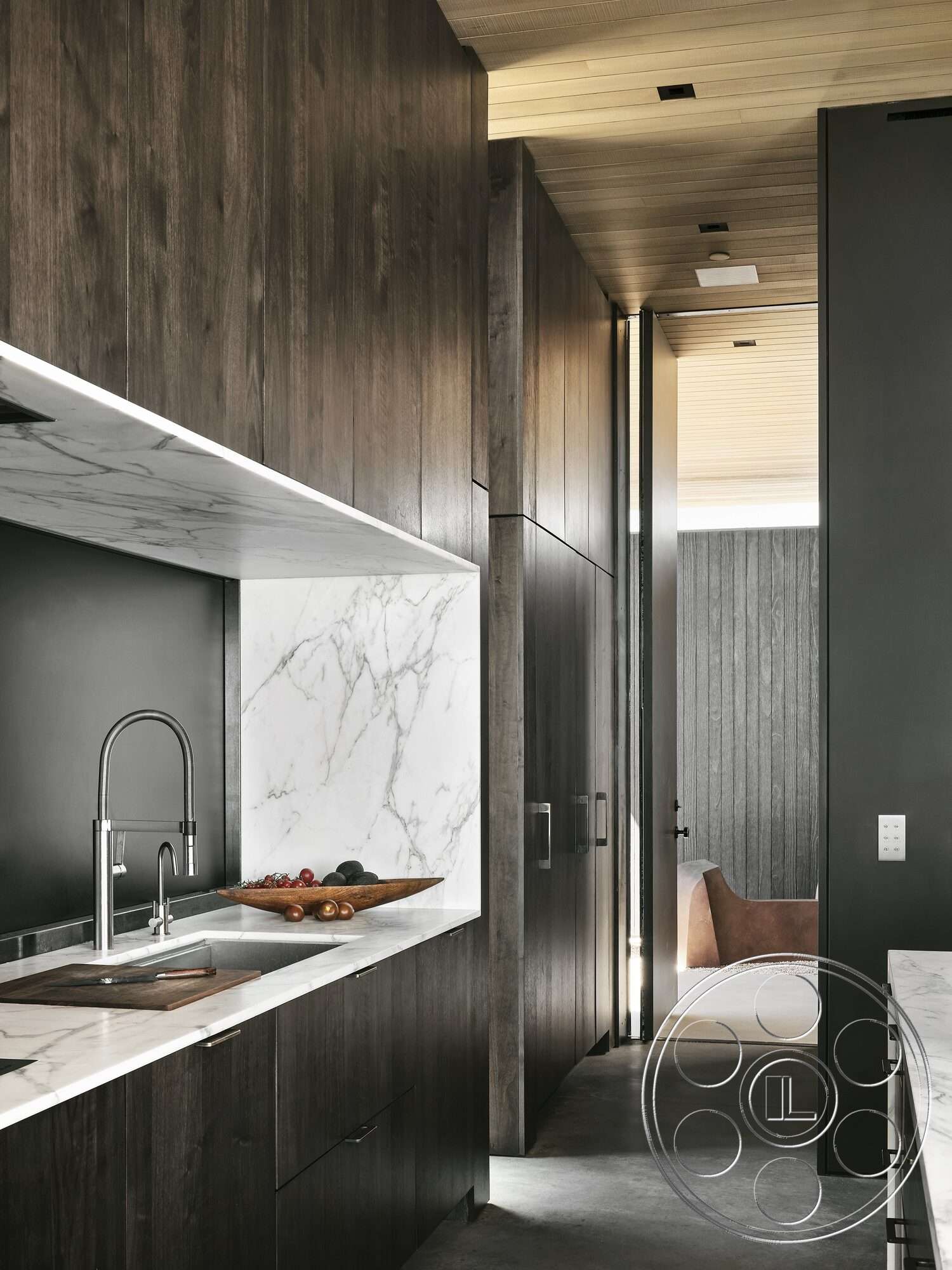 Palm Springs 110 - dark wood cabinetry, open space layout, marble backsplash, textured wooden wall, black accent wall, contemporary kitchen design, recessed ceiling lighting, marble kitchen countertop, sliding door entry, light wood plank ceiling, steel kitchen faucet