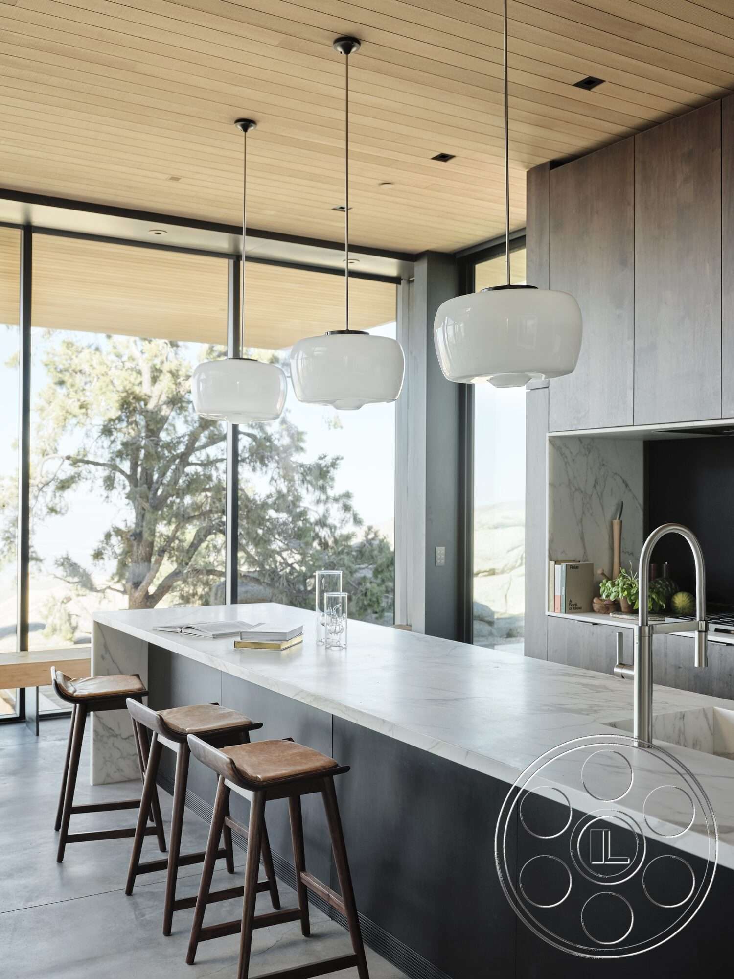 Palm Springs 110 - concrete flooring, wood panel ceiling, floor-to-ceiling windows, pendant lighting fixtures, marble kitchen island countertop, natural setting view, steel kitchen faucet, dark cabinetry kitchen, modern dining stools