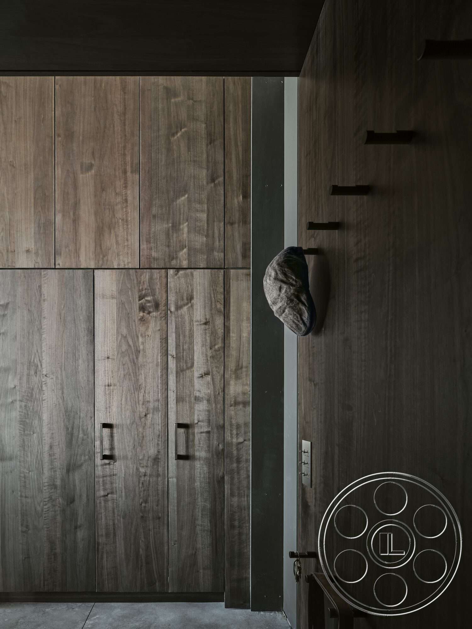 Palm Springs 110 - dark wood cabinetry, concrete flooring, modern design elements, soft lighting fixtures, monochromatic color scheme, minimalist interior, exposed wood paneling, custom built-in storage, flush handle cabinetry, industrial-style door hardware