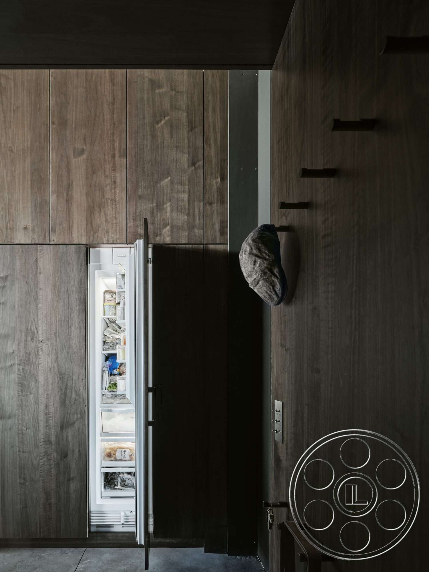 Palm Springs 110 - dark wood cabinetry, concrete flooring, modern design elements, chef's kitchen, built-in refrigerator, functional storage solutions, minimalist interior, exposed wood paneling walls, linear wall lights